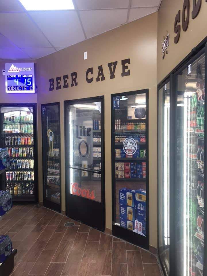 Walk-in beer cave with cold beer behind glass doors