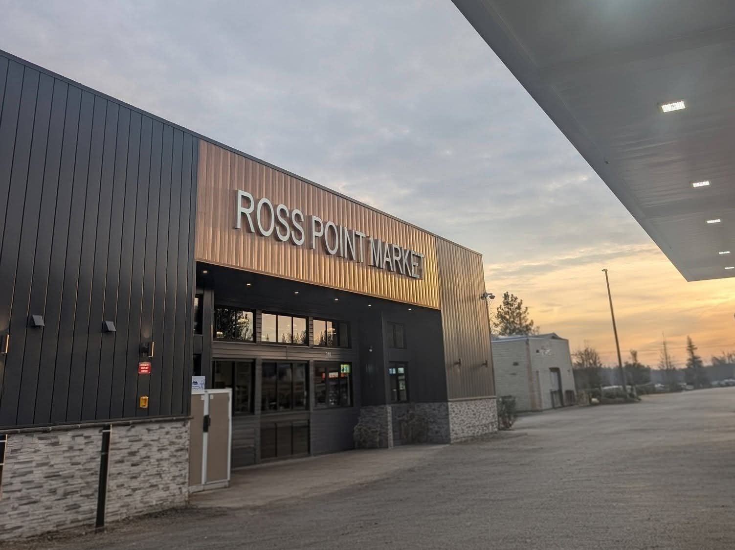 Ross Point Market storefront at sunrise, beside the fuel canopy